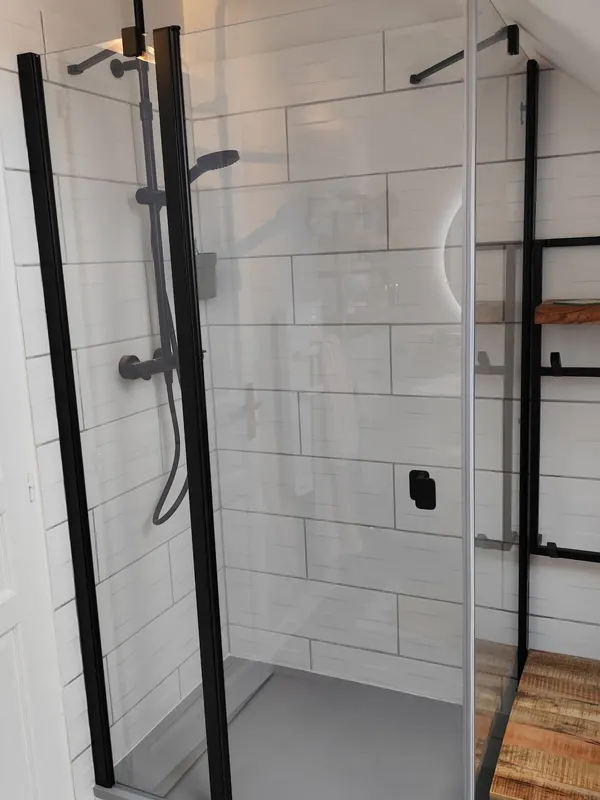 Nouvelle douche à paroi noire après rénovation de la salle de bain à Saint-Apollinaire